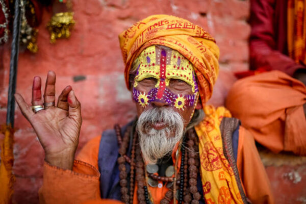 Kathmandu, Nepal - November 4 2018: Old Hindu saint happily posing for a photo.